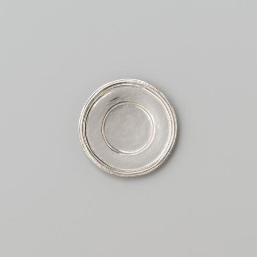 Silver-coloured small plate with broad flat profiled rim.
