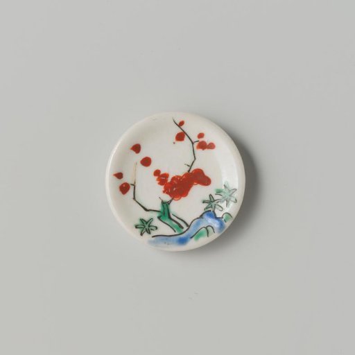Porcelain dish with polychrome decoration in Kakiemon style (flowering branches and rock)