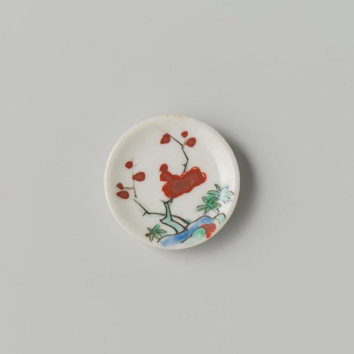 Porcelain dish with polychrome decoration in Kakiemon style (flowering branches and rock)