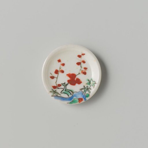 Porcelain dish with polychrome decoration in Kakiemon style (flowering branches and rock)