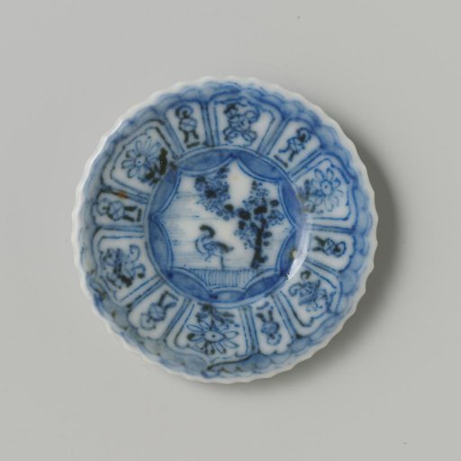Porcelain plate with blue underglaze decoration in 'Kraak' Wanli style; flat with bird (duck) under tree on shore, also decorated on the reverse