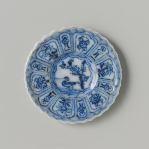 Porcelain plate with blue underglaze decoration in 'Kraak' Wanli style; flat with bird (duck) under tree on shore, also decorated on the reverse