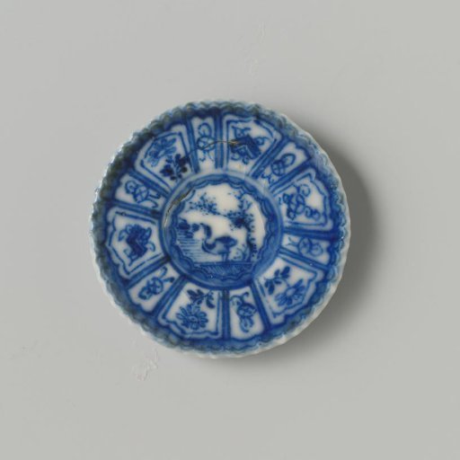 Steatite plate with blue underglaze decoration in 'Kraak' Wanli style; flat with bird (duck) under tree on shore, also decorated on the reverse