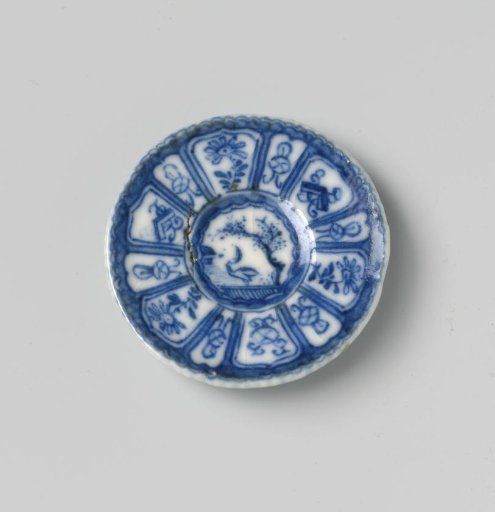 Steatite plate with blue underglaze decoration in 'Kraak' Wanli style; flat with bird (duck) under tree on shore, also decorated on the reverse