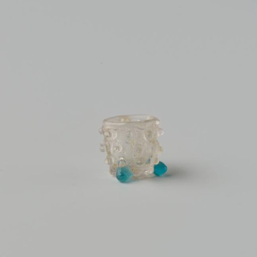 Goblet of clear colourless glass decorated with knobs standing on three ball feet.
