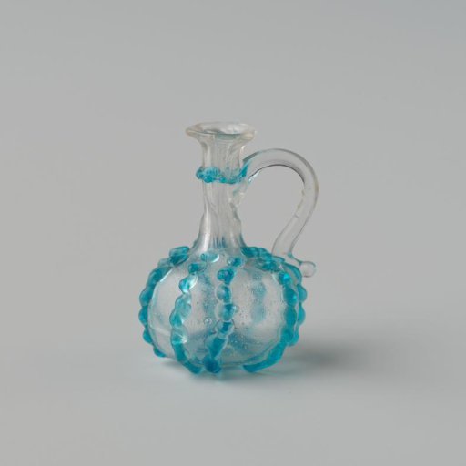 Jug of clear colourless glass, globular body decorated with eight blue pinched vertical applied ribs and a slightly indented pontil mark.