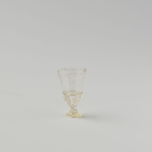 Chalice glass of clear colourless glass, high conical cup with decoration of smooth and vertical pinched glass threads on the lower part; foot partly broken.