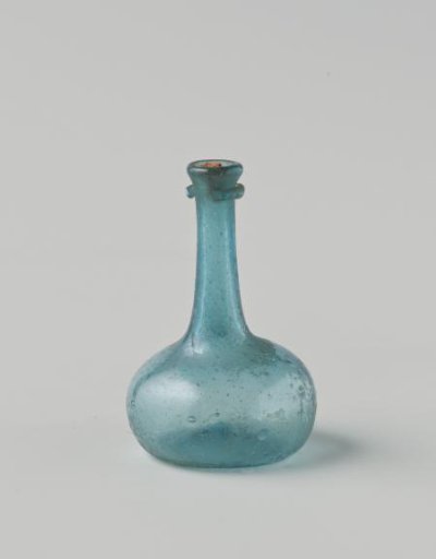 Bottle of clear light blue glass; body with few impressed eyes, high neck with drip ring; cork in neck opening.
