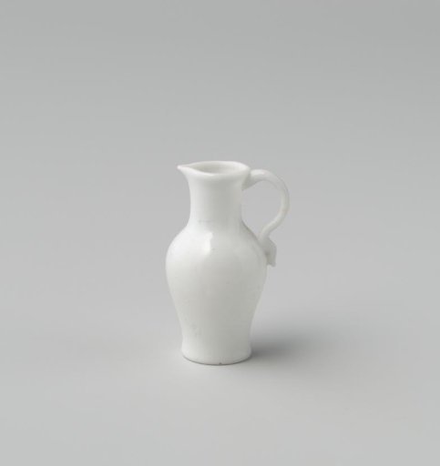 Jug of opaque white glass (probably imitation white earthenware); tall narrow model with indented base, an applied handle and spout