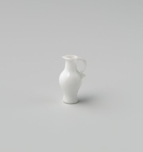 Jug of opaque white glass (probably imitation white earthenware); tall narrow model with indented base, an applied handle and spout