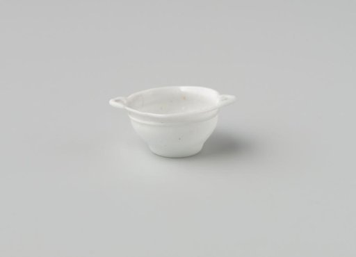 Bowl of opaque white glass (probably imitation white earthenware); indented base. two flat applied handles and applied glass thread under the upper rim.