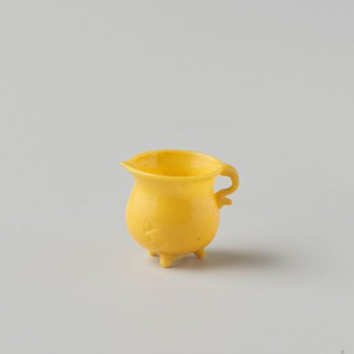 Cooking jug of opaque yellow glass (probably imitation yellow earthenware); on three feet with spout and handle.