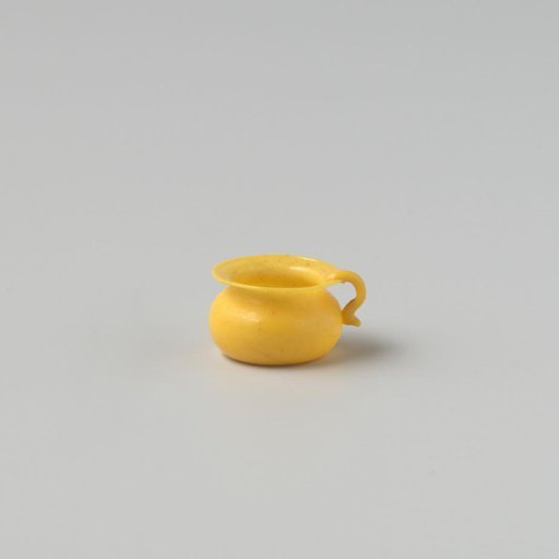 Chamber pot of opaque yellow glass (probably imitation yellow earthenware), low model with indented base, flat rim and an applied handle.