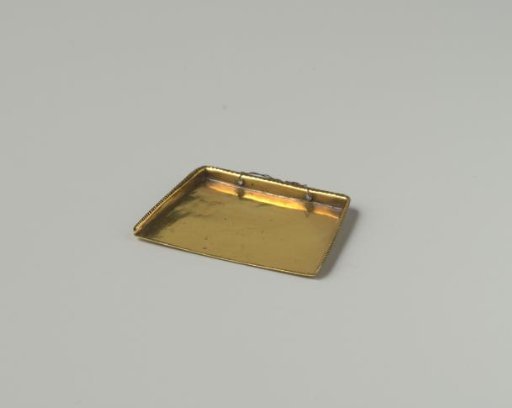 Dustpan of brass, raised edges decorated with grooves; handle broken and replaced with a thin copper wire