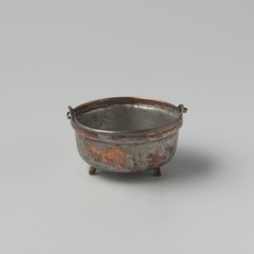 Wide copper cooking pot, tinned inside and out, on three low triangular feet; the pot can be hung over the fire with a wrought iron handle