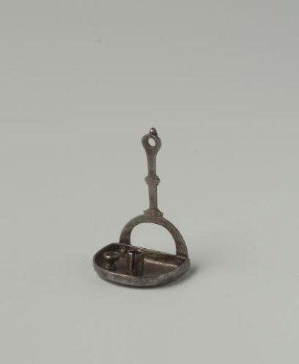 Wall-mounted taper stand of wrought iron, consisting of a base with raised rim, upon which a candlestick and a small dish on a foot are placed