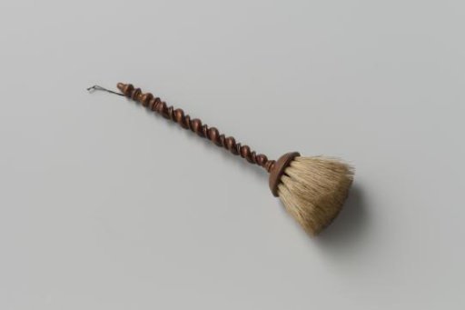 Walnut and boar's hair chamber broom; round profiled head and finely turned stem with double twist (narrow and wide), baluster and knob, to which a cord (new) is attached