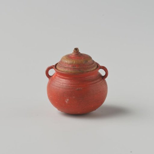 Cooking pot of red lacquered wood; with two handles, loose lid with (broken) knob; originally the pot stood on three feet (missing)