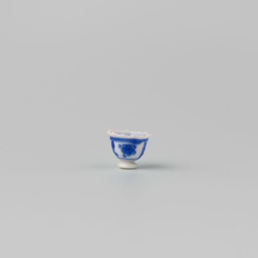 Milk glass teacup with blue enamel painting, imitation Chinese porcelain with 'flower' decoration in panels; model on a separately attached foot ring with a pointed rim.