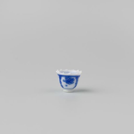 Milk-glass teacup with blue enamel painting, imitation Chinese porcelain with 'flower' decoration in compartments; model on a separately attached foot ring with a pointed rim.