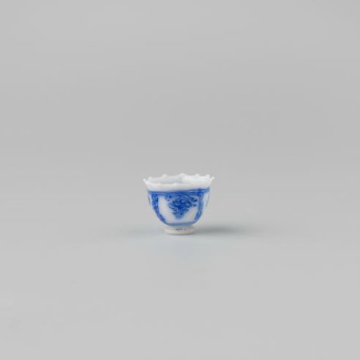 Milk-glass teacup with blue enamel painting, imitation Chinese porcelain with 'flower' decoration in compartments; model on a separately attached foot ring with a pointed rim.