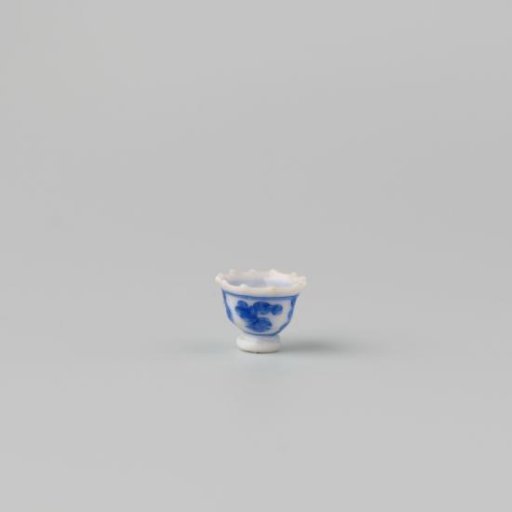 Milk-glass teacup with blue enamel painting, imitation Chinese porcelain with 'flower' decoration in compartments; model on a separately attached foot ring with a pointed rim.