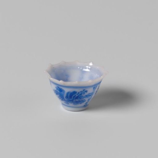 Milk-glass teacup with blue enamel painting, imitation Chinese porcelain with 'flower' decoration in three compartments; model with a pointed rim, barely a foot ring.