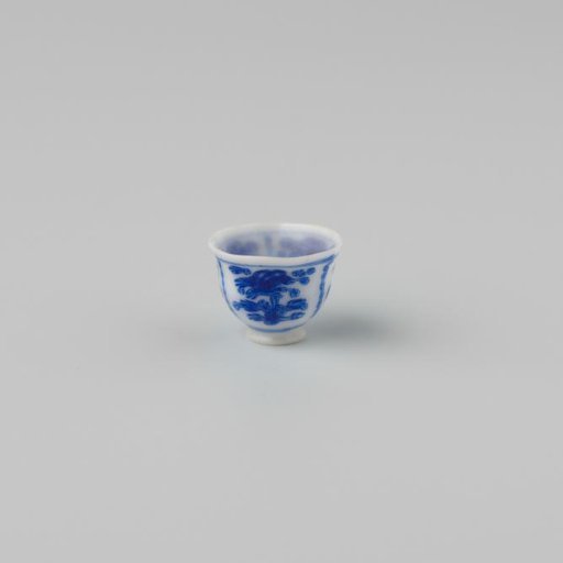 Milk-glass teacup with blue enamel painting, imitation Chinese porcelain with 'flower' decoration in compartments; on a foot ring with a smooth rim.