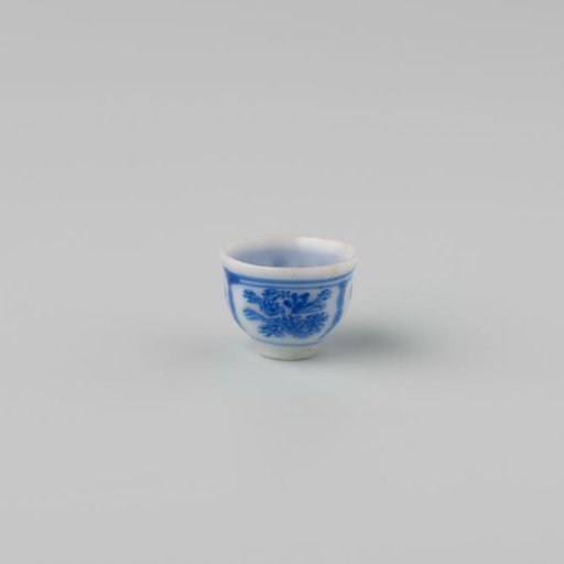 Milk-glass teacup with blue enamel painting, imitation Chinese porcelain with 'flower' decoration in compartments; on a foot ring with a smooth rim.