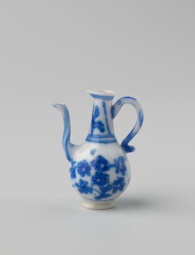 Milk-glass jug with blue enamel painting, imitation Chinese porcelain; decoration of two flower branches on the body and flowers in two panels on the neck. Pear-shaped.