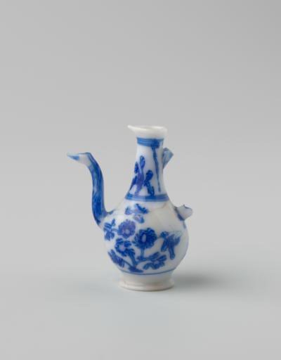 Milk-glass jug with blue enamel painting, imitation Chinese porcelain; decoration of two flower branches on the body and flowers in two panels on the neck. Pear-shaped.
