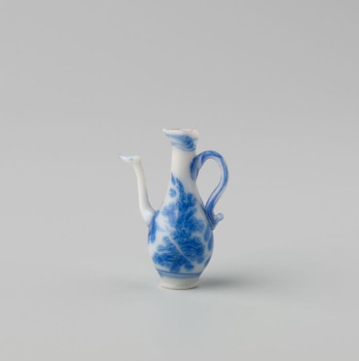 Milk-glass jug with blue enamel painting, imitation Chinese porcelain; flowering branches on the body continuing onto the neck. Pear-shaped with handle and spout and a pouring lip.