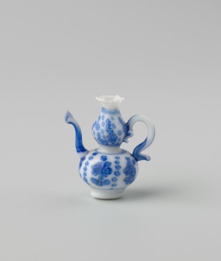 Milk-glass jug with blue enamel painting, imitation Chinese porcelain; flowers in panels; model a knobbly flask on a stand ring with spout and S-shaped handle.