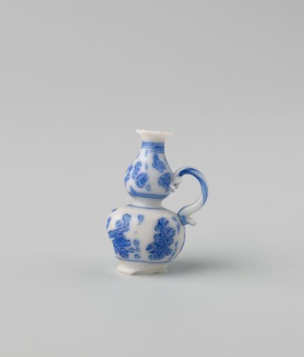 Milk-glass jug with blue enamel painting, imitation Chinese porcelain; flowers in panels; model a knobbly flask on a stand ring with spout and S-shaped handle.