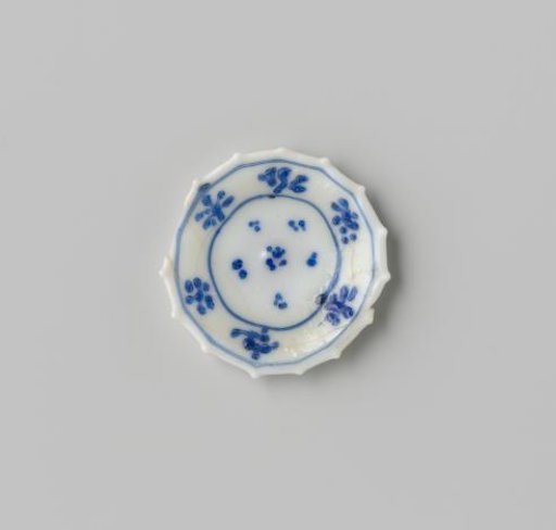 Milk glass dish with blue enamel painting, imitation Chinese porcelain; dots in the flat, rim with six flowers; double-walled with rim pinched into points.