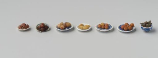 Various fruits, made of wax, including 6 oranges, 4 lemons, 5 peaches, 5 apples, 4 plums, 1 pear and 2 bunches of grapes
