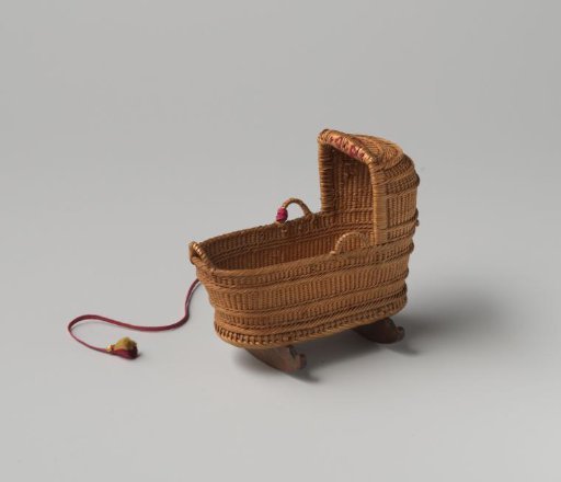 Cradle, made of split willow wood, resting on two legs of walnut