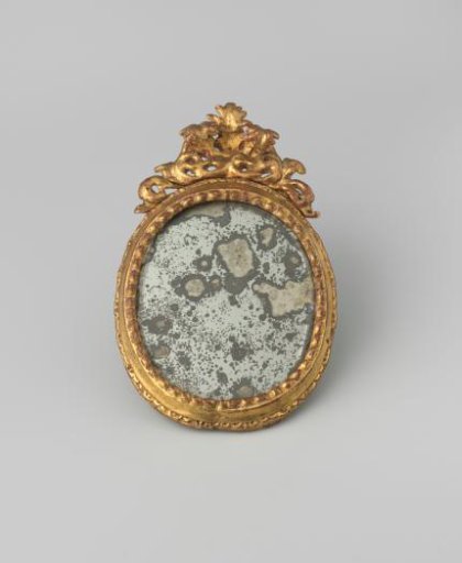 Oval mirror in a gilded wooden frame. In the frame strongly corroded mirror glass with cut facet edge, at the back closed by wooden panel