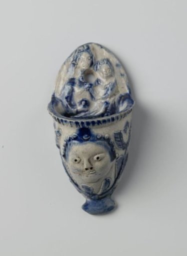 Holy water stoup with an angel's head and Madonna and Child