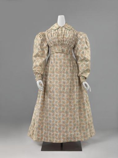 Skirt with smooth front, pleated back and side slits of unlined white cotton with brown work in oval with black dots and colored diamond-shaped floral ornament