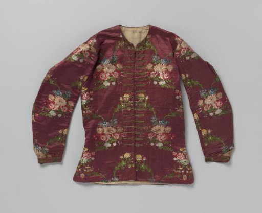 Straight jacket with long sleeves, armholes, and 17 elongated and 17 round buttonholes with green embroidered borders, made of burgundy silk with large multicolour embroidered flowers.