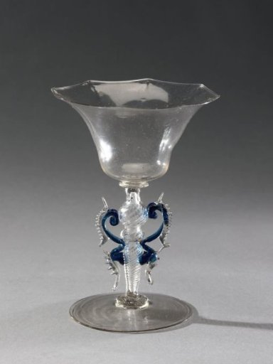 Winged glass with a bell-shaped stem and an octagonal rim
