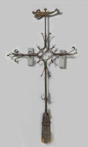 Tower cross with arms ending in lilies. Weather vane in the shape of a sea monster