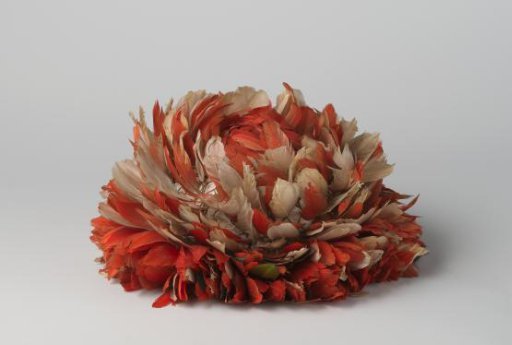 Cap with red and white feathers fixed on braided cord
