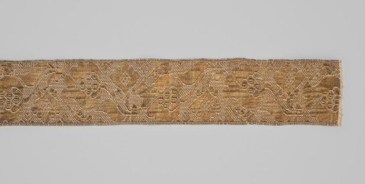 Gold braid of yellow silk, interwoven with gold in a pattern of stylized tulips on branches with leaves