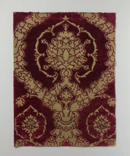 Fragment of silk velvet brocade on a gold ground with a pomegranate pattern