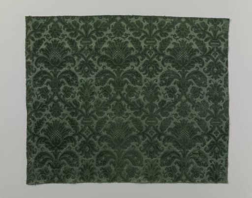 Fragment of silk velvet brocade with a stylized pattern of flowers and leaves in diamond shape