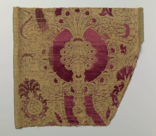 Fragment of silk velvet brocade with a pattern of flowers and fruits in red and gold