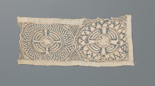 Fragment of needle lace with two suns