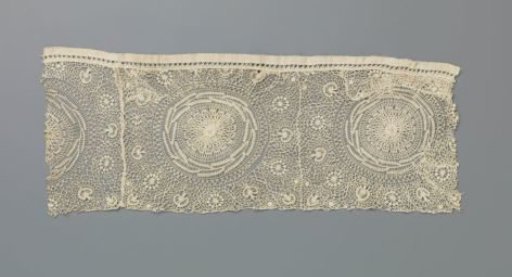 Strip of needle lace with suns and sheaves of corn